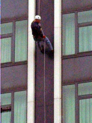 Lisburn Cathedral vicar, the Rev Ken McGrath abseiling down the Europa Hotel. 